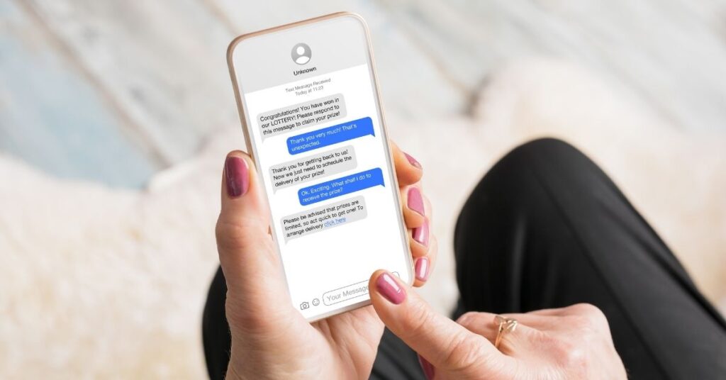 A woman receives spam texts on her mobile phone.