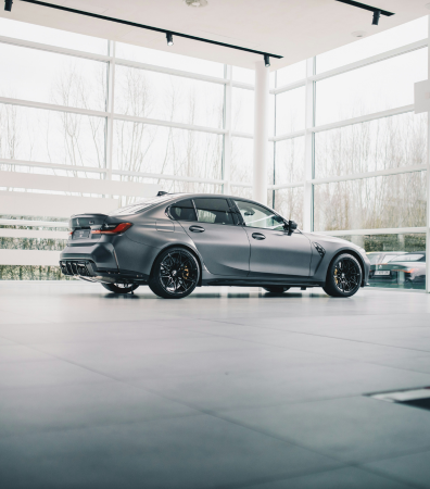 A car sitting alone in a showroom.