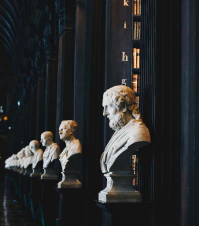 A row of busts lining an old library. AML checks for solicitors.