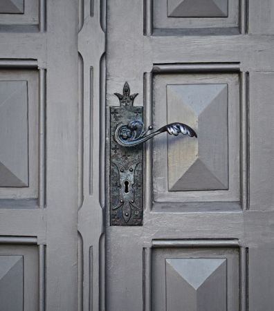An ornate door handle. Right to rent checks.