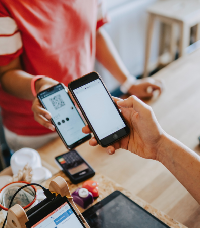 Someone scans a QR code from their phone, enabling secure payments.