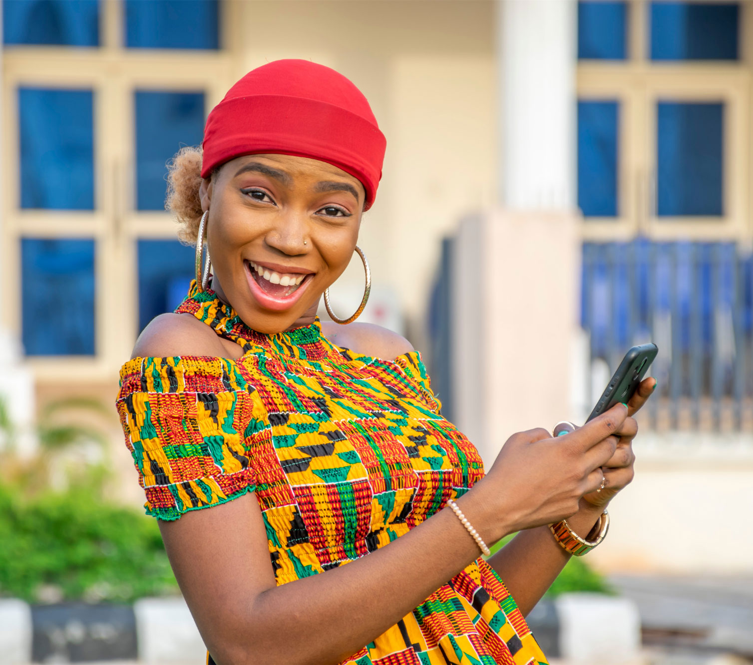 A cheerful woman holding her phone.
