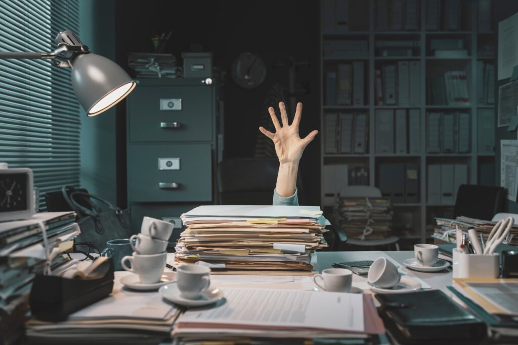 Desperate office worker overwhelmed with paperwork, she is asking help with her hand