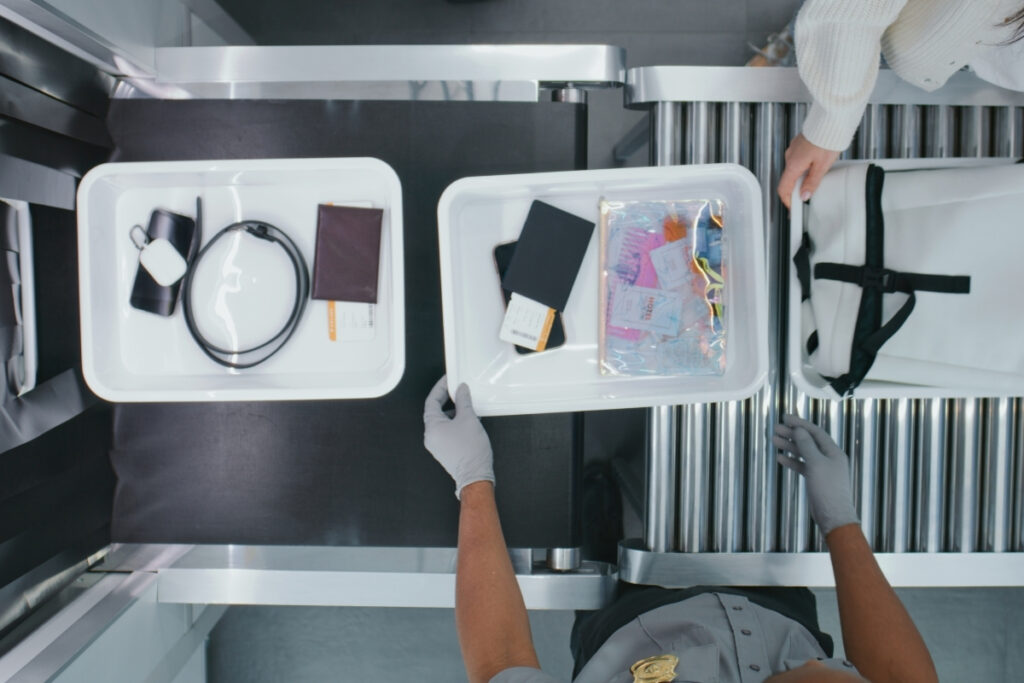 Baggage being passed through security checks. What is an AML check?