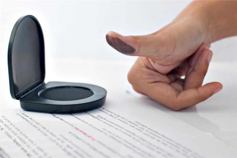 Inking a fingerprint is like a biometric ID check.